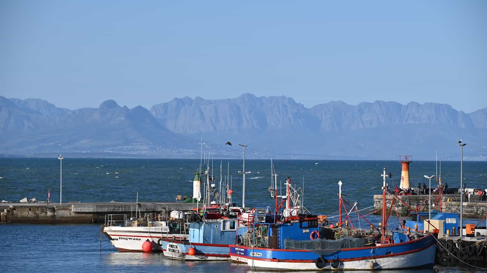 Kalk Bay harbour boats with the False Bay mountains behind