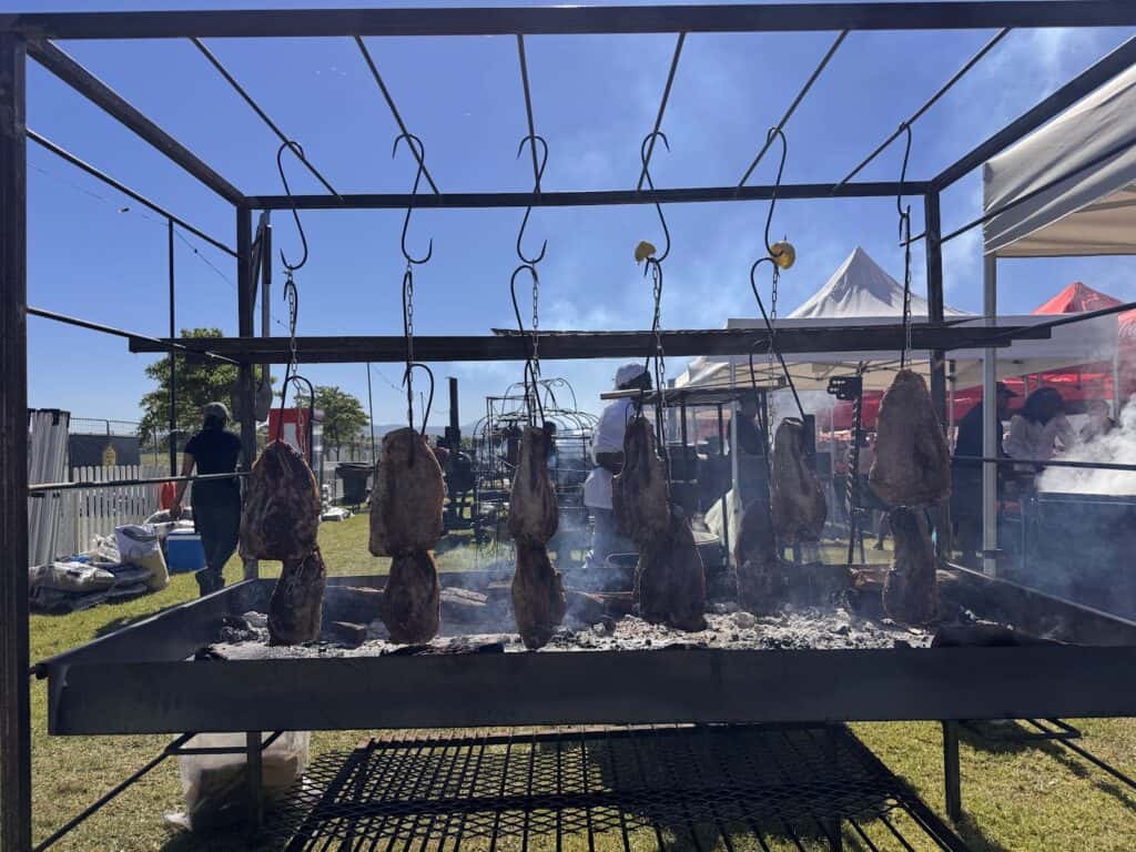 Meat hanging over our coals at the SA Barbecue Festival 2026, Sandringham Farm